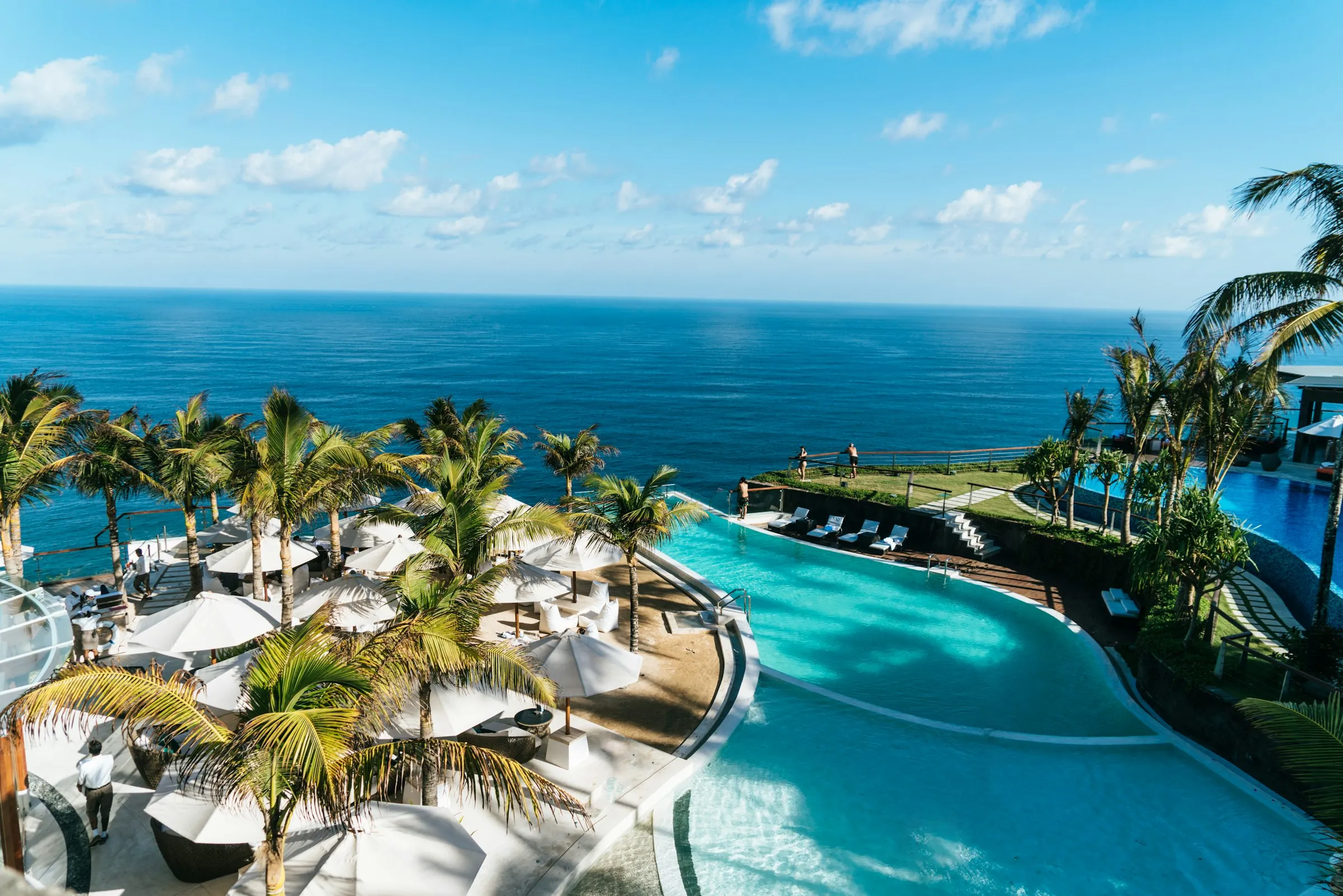 Aerial view of a luxury resort pool beside the ocean