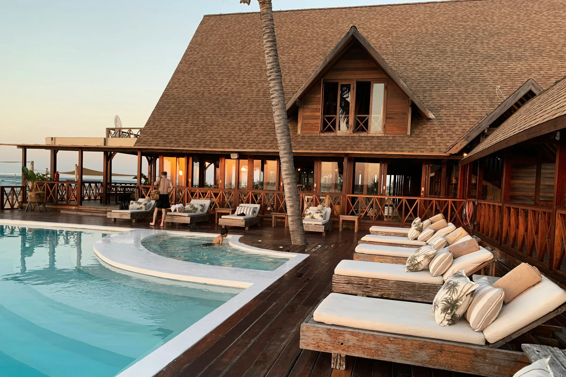 A resort pool deck lined with sun loungers